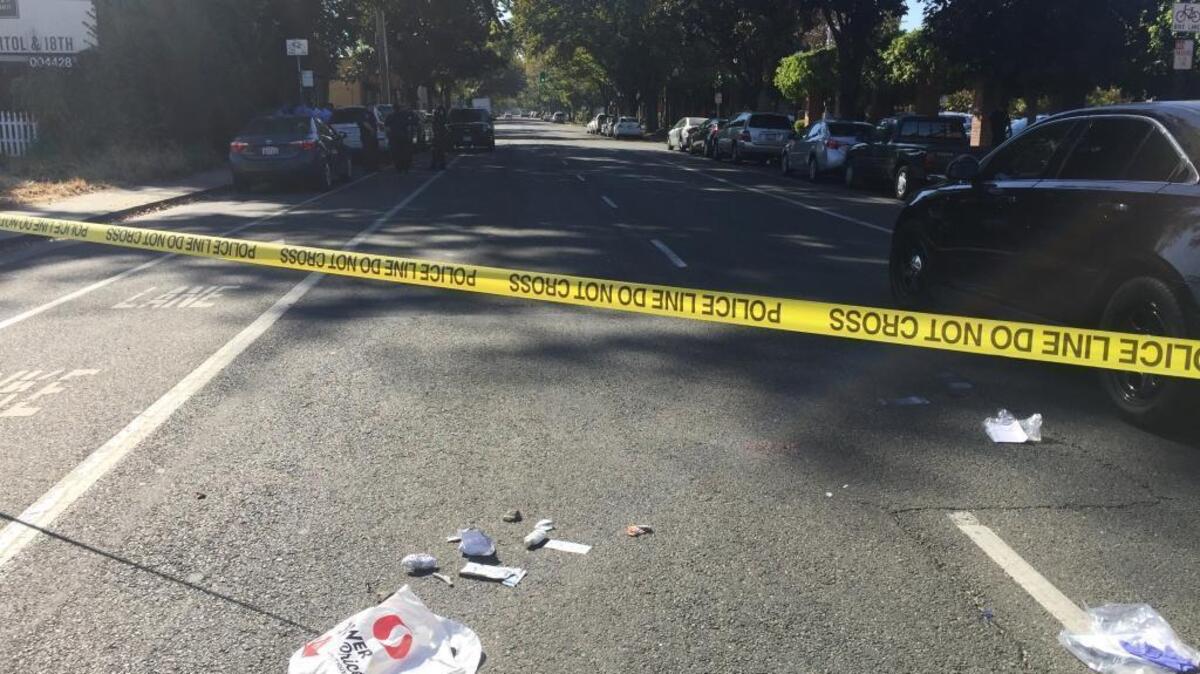 A plastic shopping bag, scraps of paper and other debris remain on 19th Street between Q and S streets in Sacramento after emergency responders took a man to a local hospital Tuesday morning after he was found unconscious in the street.