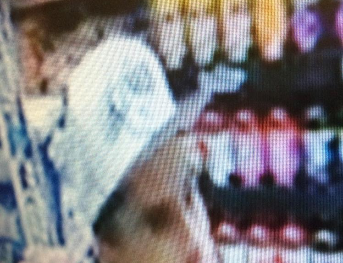 A surveillance photo shows a man sought in the robbery of a North Auburn gas station.
