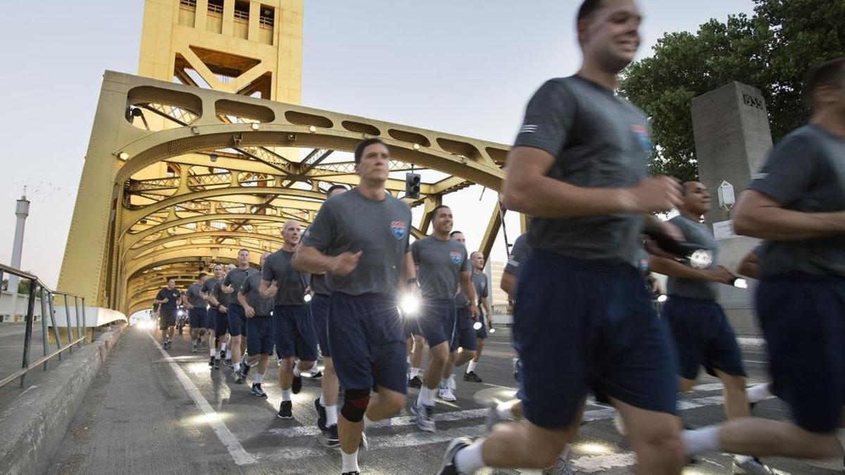 Graduating California Highway Patrol cadets cross Tower Bridge during their 5-mile run from the CHP Academy in West Sacramento to the California Peace Officers’ Memorial across from the Capitol on Wednesday, Aug. 10, 2016, in Sacramento.