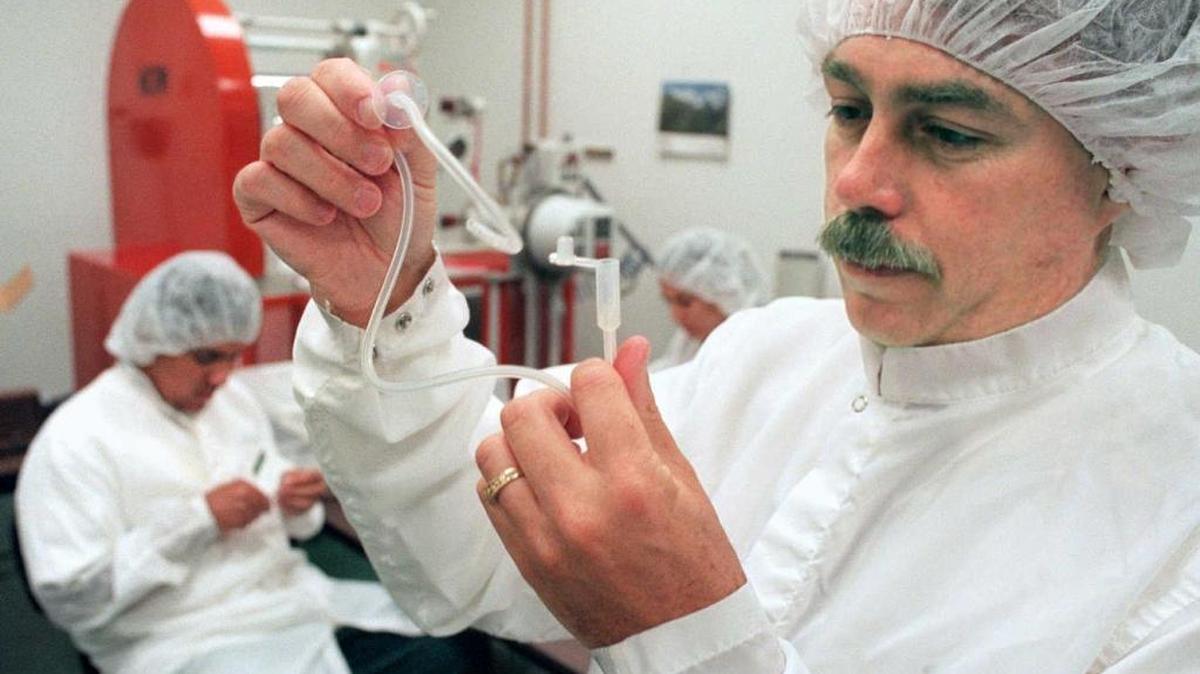 Briant Benson examines a Robertson Suprapubic Drain manufactured out of silicone rubber at his company’s Sacramento manufacturing facility in May 1998. The chief executive of Bentec Medical in Woodland was sentenced to one year in prison Friday for tax evasion.