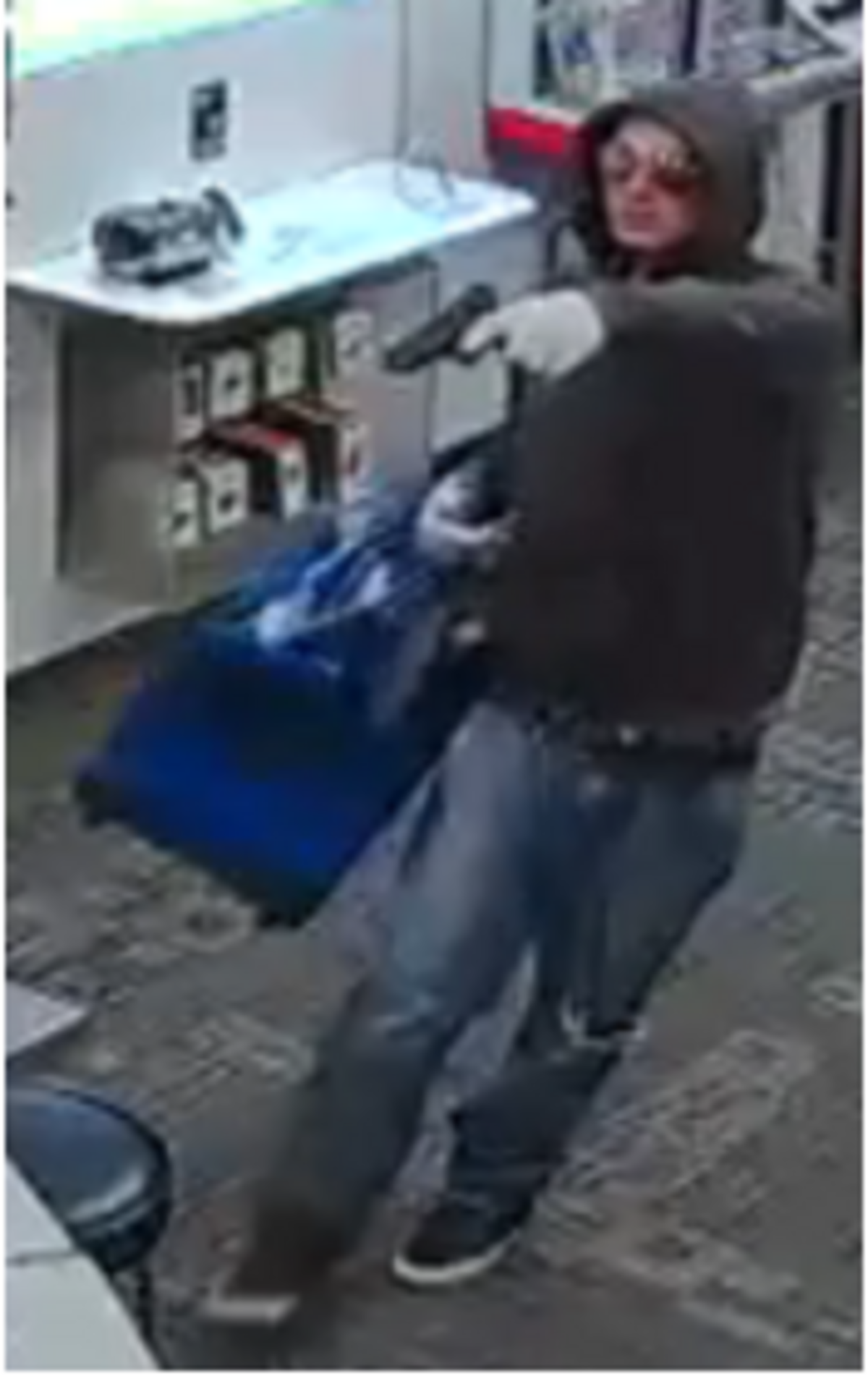 Surveillance video shows a man pointing a gun at a Verizon Wireless employee during an Oct. 29 robbery.
