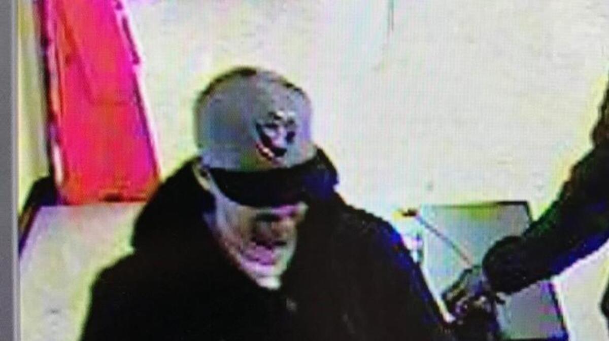 An Oakland Raiders cap and white T-shirt similar to those in this photo were reportedly found in Corey Lewis Johnson’s car.