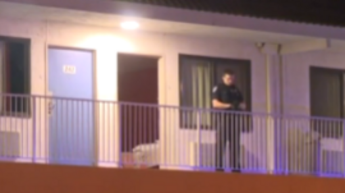 Police investigate the scene at a Motel 6 in West Sacramento.