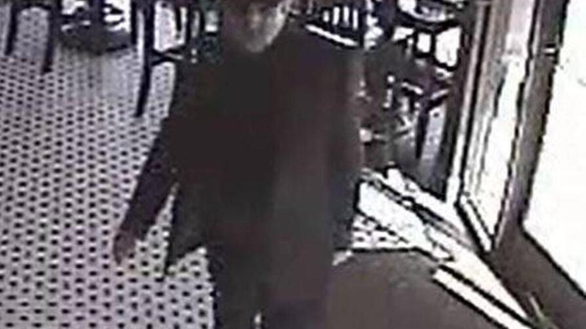 A surveillance photo shows a man accused of taking a woman’s wallet from her purse at a Roseville restaurant.