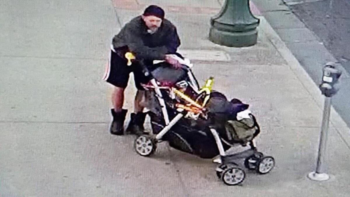 The man Stockton police want for stealing parking meters chills out near a possible object of thieving desires.