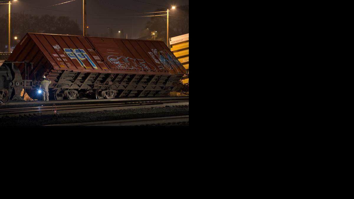 
Emergency crews check the underside of a derailed car in the rail yard where seven cars derailed near the Home Depot store in Antelope on January 5, 2015.
