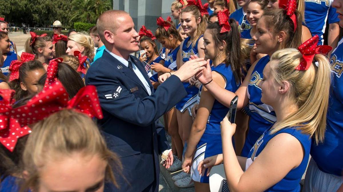 
Spencer Stone shakes hands with cheerleaders from Del Campo High School after he took part in the “Hometown Heroes” parade on Sept. 11 in Sacramento.
