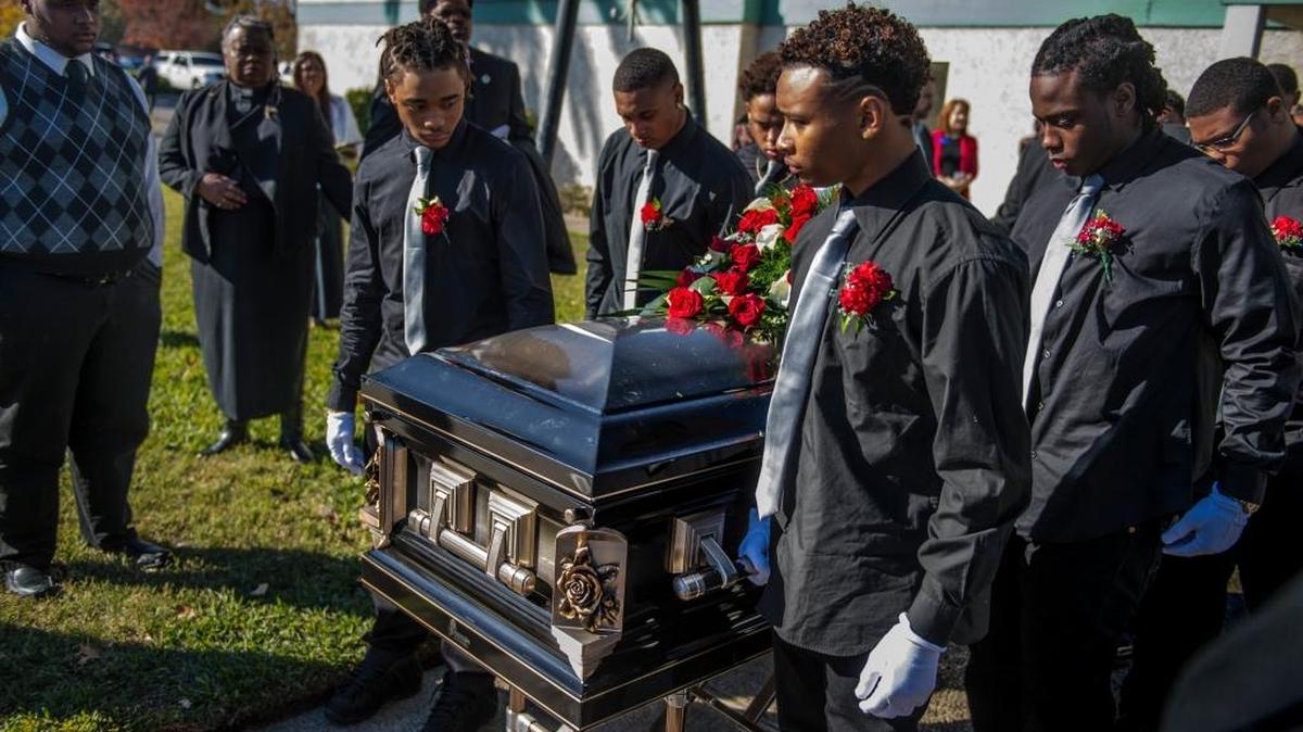 Pallbearers, family and friends of Jaulon "JJ" Clavo, escort his coffin to the hearse on Saturday, Nov. 28, 2015, in Sacramento, Calif. Hundreds of mourners gathered at Calvary Christian Center in North Sacramento on Saturday morning to remember Jaulon "JJ" Clavo, the Grant High School football cornerback shot and killed earlier this month.