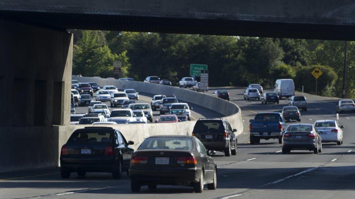Cars are bottle necked under the train overpass after driving past the E street entrance on the Capital City Freeway during rush hour in Sacramento, Calif.