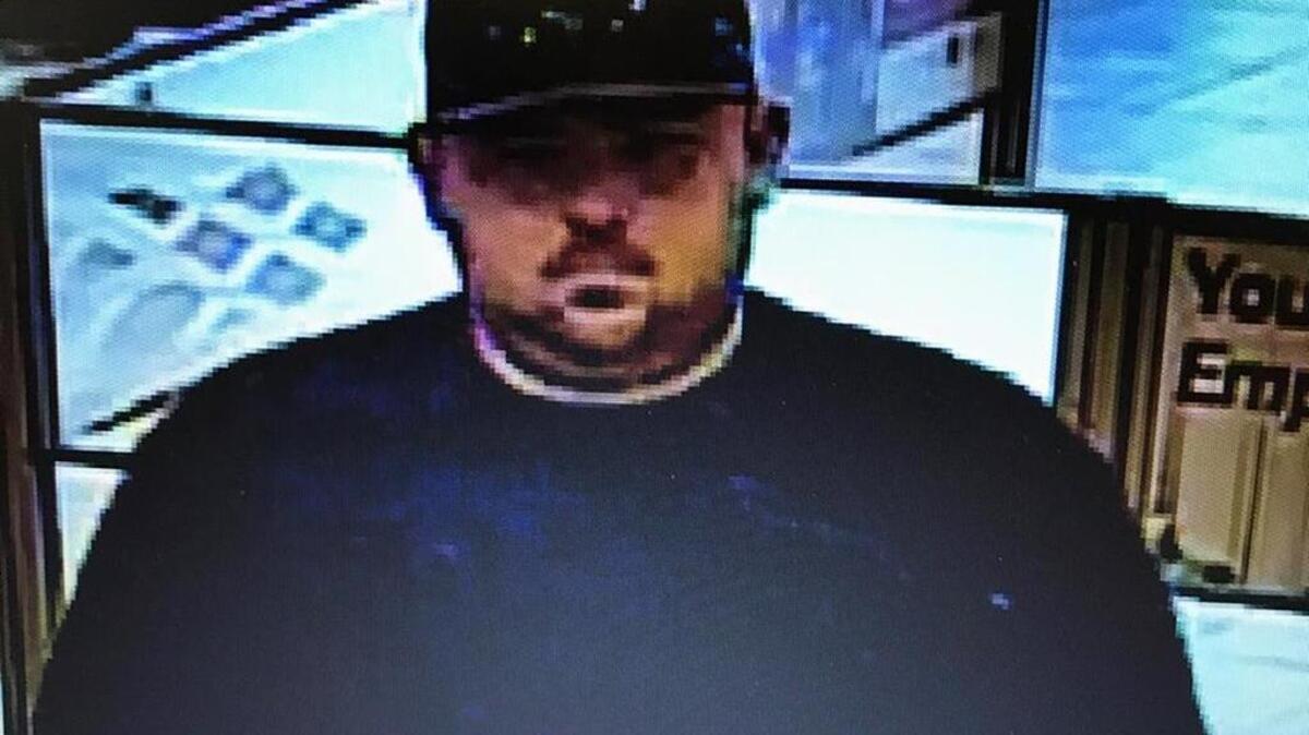 Surveillance photos show a man suspected of robbing a bank in the 2800 block of Marconi Avenue on Aug. 10, 2017.