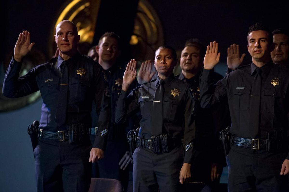 Sabrina Briggs, takes the oath with Don Bevins, left, and Justin Thompson, right, at the Sacramento Police Department promotions ceremony at the Crest Theatre on Friday, December 1, 2017. All three were promoted to sergeant. Briggs is the first African-American woman to be promoted to sergeant in the Sacramento Police Department.