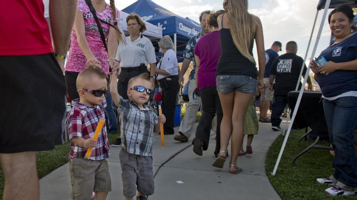 
Twins Wyatt and Kaleb Gossage, 2, stroll with their mother, Casandra Gossage, at Freedom Park in North Highlands as they participate in National Night Out.


