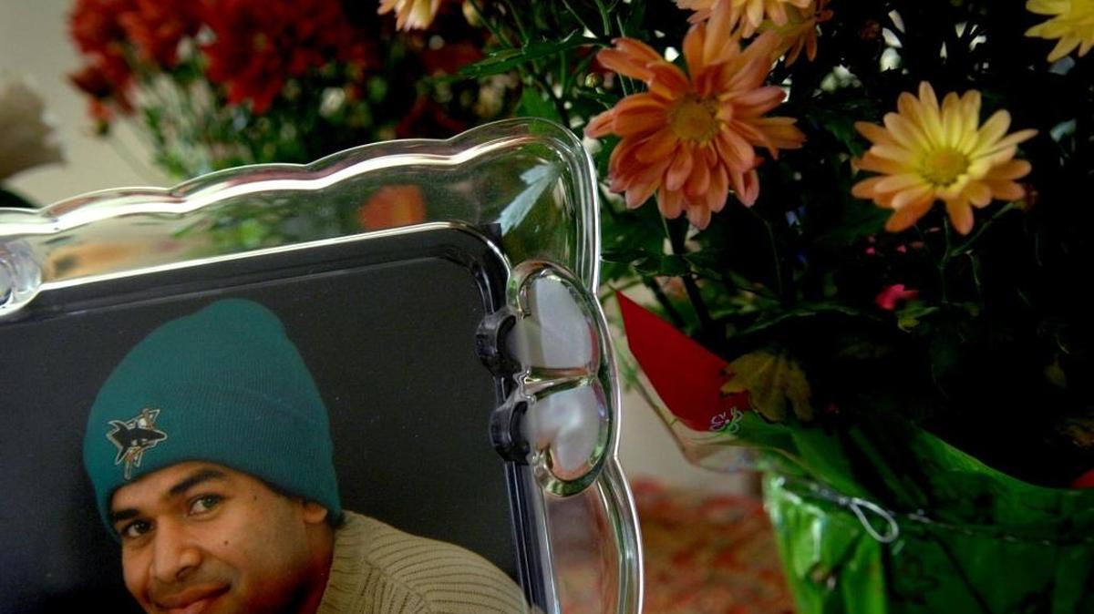 A photograph of Satender Singh sits on his grandmother's table surrounded by flowers on July 12, 2007. Singh was fatally beaten in an attack at Lake Natoma.