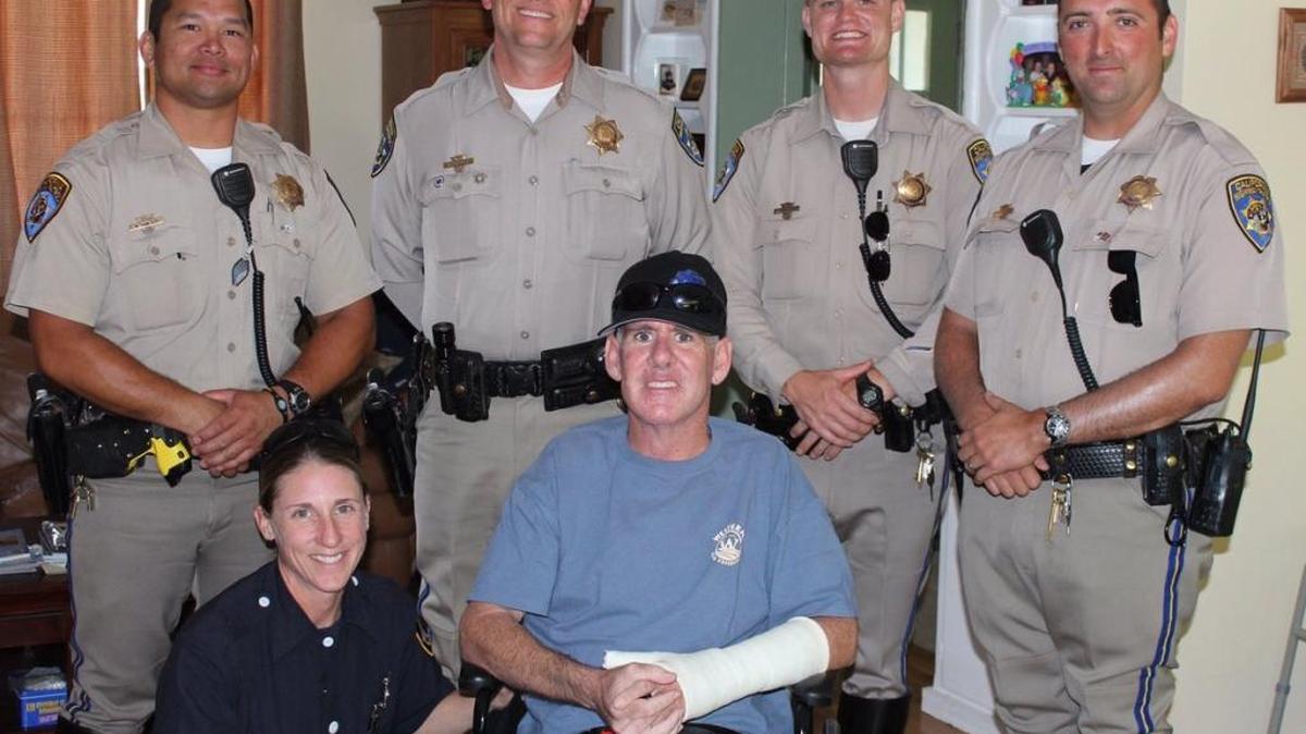 CHP officer Michael Ericson is shown at home with fellow CHP officers and Sharon McIntyre, a Sacramento Fire Department firefighter-paramedic who rendered aid when she came upon the I-80 crash scene.