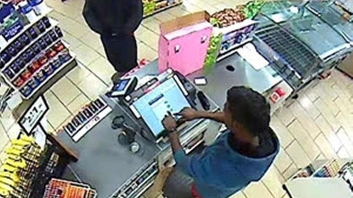 Robber confronting clerk