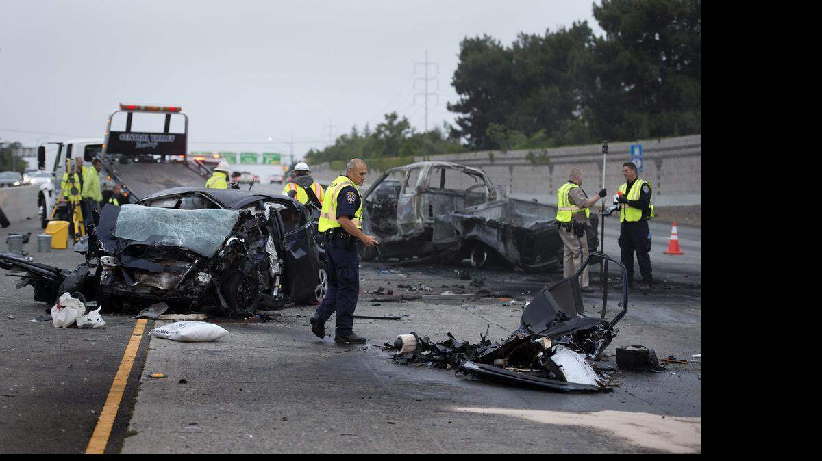 
Officials investigate the crash on westbound Highway 50 where four people died after a wrong-way driver slammed into a pickup near Stockton Boulevard early Wednesday in Sacramento. The collision resulted in the death of the wrong-way driver, a woman in the Toyota Prius at left, and three men in the Ford pickup at right. They died at the scene of the 2:30 a.m. crash.
