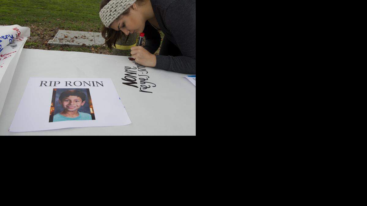 
Nonie Reyes-Small, 16, president of the National Alliance on Mental Illness club signed a pledge to stand up against bullying before she gave out yellow ribbons for suicide prevention before a balloon release for Ronin Shimizu on Tuesday, Dec. 9, 2014 at Folsom High School in Folsom, Calif. Shimizu,12, committed suicide Dec. 3rd.
