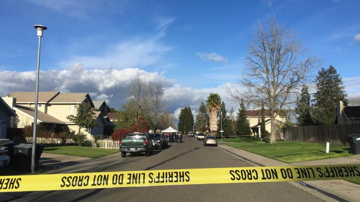 Homicide detectives and other officials gathered near a house in the 7600 block of Countryfield Drive in south Sacramento County where a 2-year-old reportedly shot herself, March 8, 2016.
