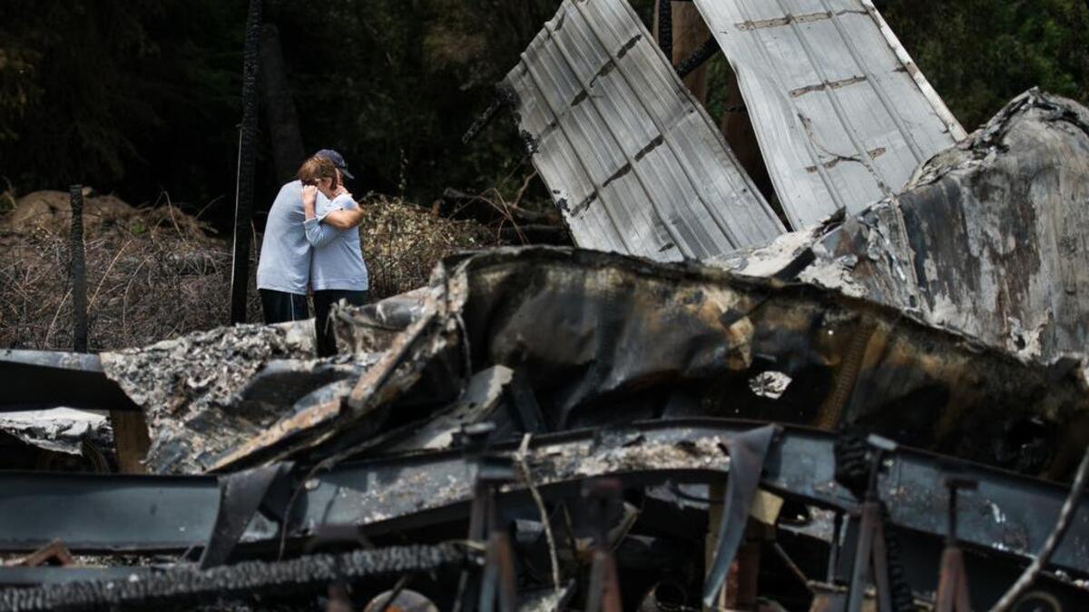 
Peter McNally embraces his mother, Sheila McNally, whose Brannan Island home was destroyed in a fire that ripped through the Pirate’s Lair Marina community near Isleton on Thursday. Sheila McNally had recently listed the home for sale to help with her retirement.
