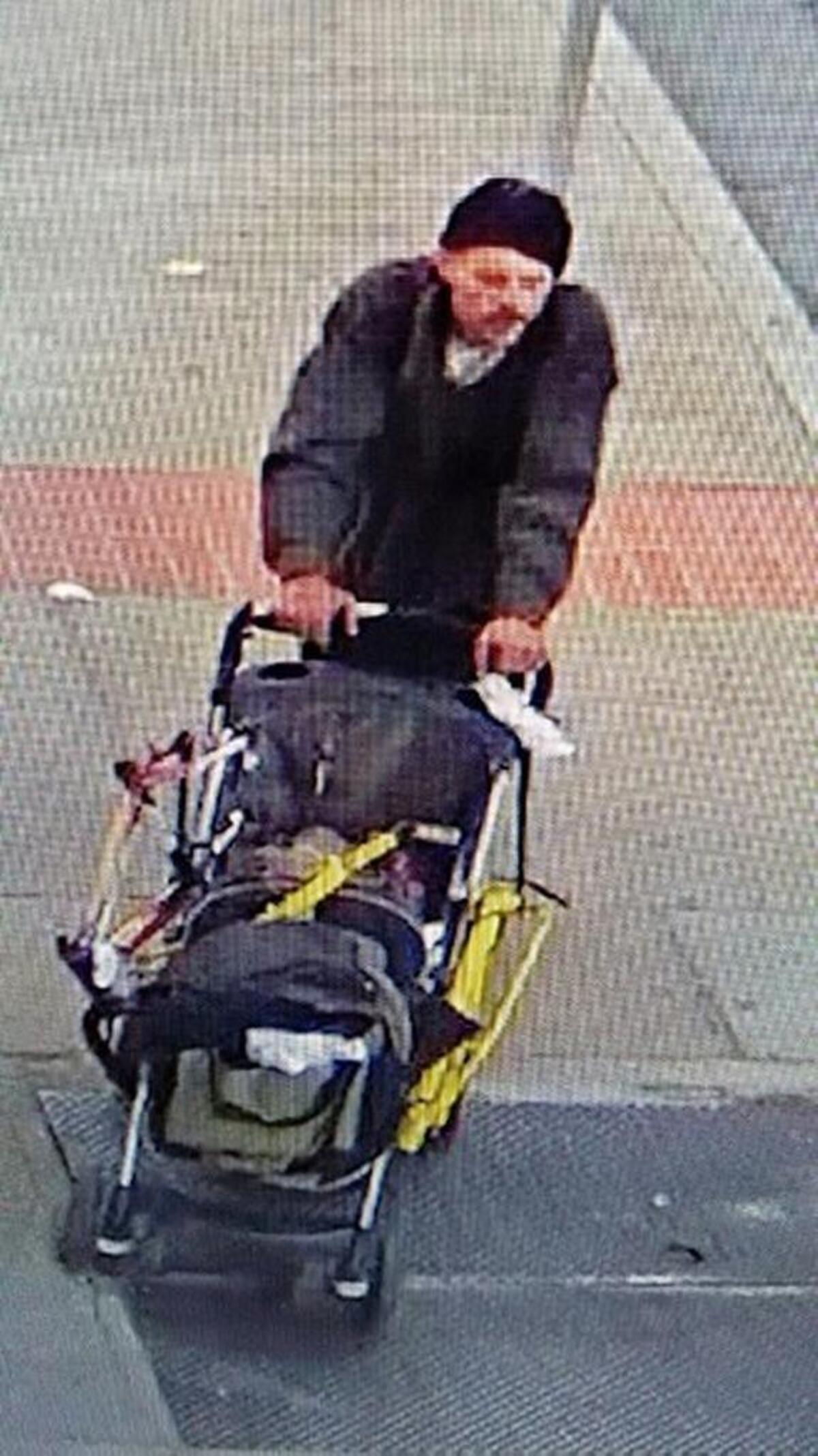 The man Stockton police want for stealing parking meters pushes his get-away stroller on a city street.