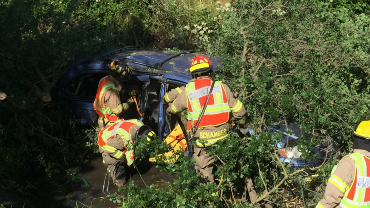 Cosumnes Fire Department firefighters work to extricate a driver from a vehicle that ended up in a ravine at Elk Grove-Florin Road and Valley Oak Lane.