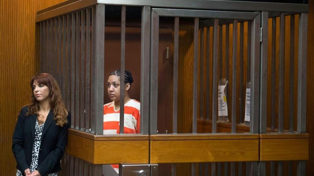 Porche Latrice Wright, who stands inside a courtroom cell next to her attorney Amanda Reeves, is sentenced to 10 years to life in Sacramento Superior Court on Wednesday, Feb. 25, 2016 in Sacramento, Calif. Wright was sentenced in a plea deal for pouring gasoline on her 7-year-old daughter and setting the girl ablaze last year. The girl survived.