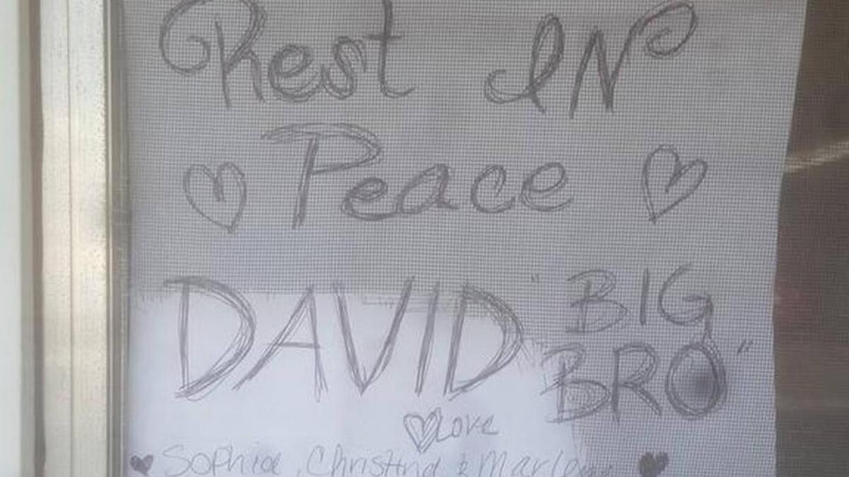 Three women put up this sign in the window of the mobile home where David Antonio Ortega II, 37, was fatally stabbed. They would not identify themselves for a reporter.