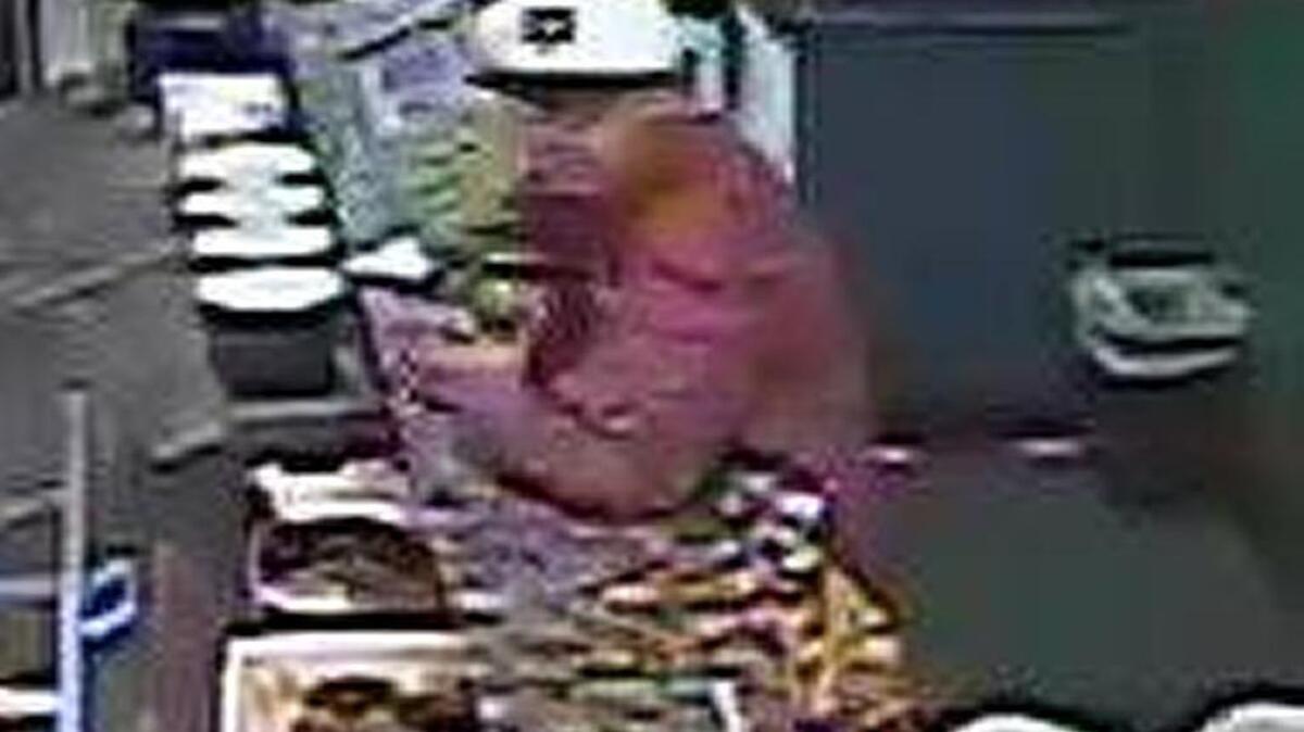 A surveillance photo shows a man suspected of robbing the Mr. Pickles sandwich shop in Granite Bay.