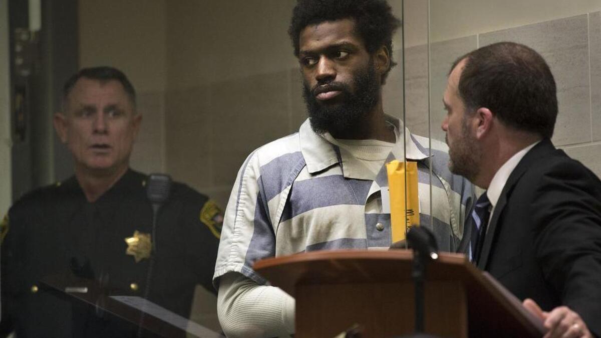 Markeese Carter stands near his attorney Ron Johnson in Yolo County Superior Court during his arraignment Friday on charges he murdered his 4-year-old daughter.