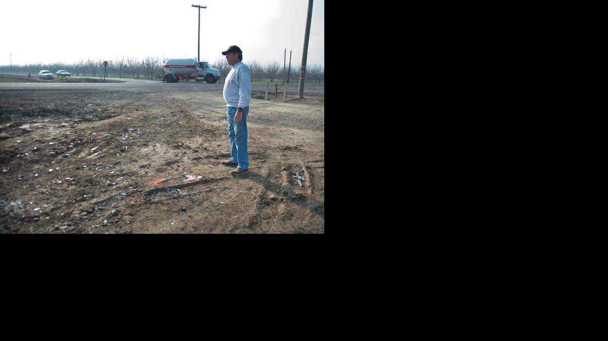 
Ron Ryan looks at the scene where five people were killed Tuesday when a pickup hit a minivan near Farmington.
