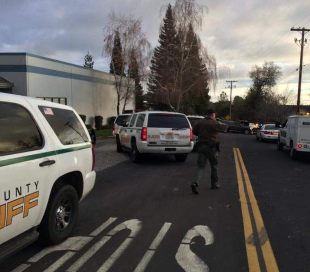 
Law enforcement vehicles and personnel set up near the site of a shootout on the outskirts of Auburn on Sunday afternoon.
