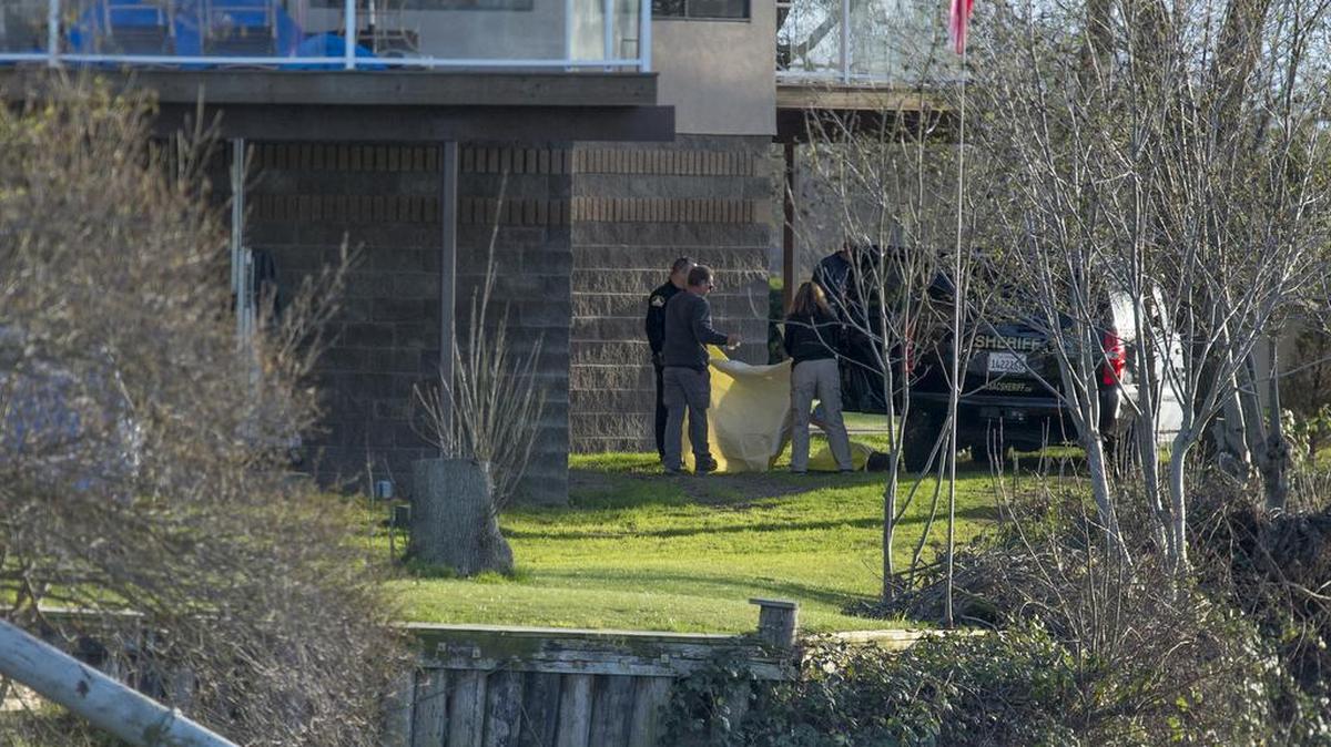 Members of the Sacramento County Sheriff’s Department cover the body of an adult man who was found in Steamboat Slough, about 5 miles south of Grand Island Mansion, on Monday, Feb. 22, 2016, in Walnut Grove, Calif. The Sacramento County Coroner’s Office confirmed that the body was that of Prasad Moparti, who went missing within hours of his daughter’s wedding at the mansion.