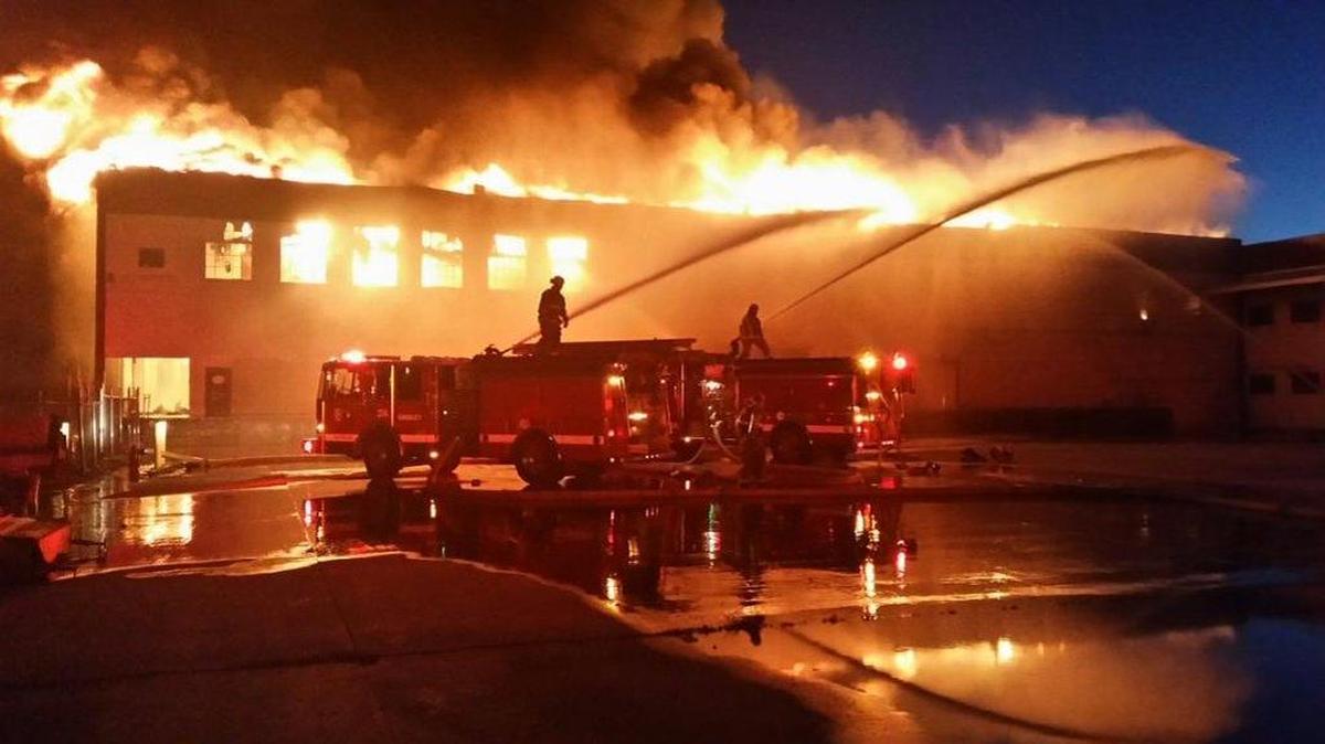Fire personnel battle a blaze Wednesday night at a vacant 100,000-square-foot cannery complex in the 100 block of Kentucky Street in Gridley.