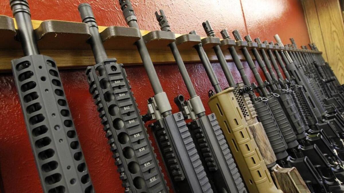 In this July 20, 2012, file photo, a row of different AR-15 style rifles are displayed for sale at the Firing-Line indoor range and gun shop in Aurora, Colo.