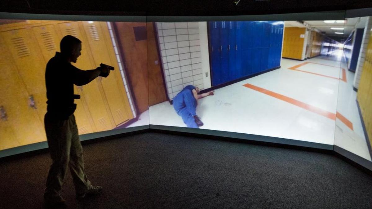 Sacramento police training officer Jacob Casella demonstrates a Force Options Simulator exercise at the Sacramento Police Academy in McClellan, Calif., on Thursday, Aug. 11, 2016. The simulators are designed to increase trainee knowledge, skills and confidence in a safe, challenging environment that is interactive and engaging. The scenarios provide officers and academy recruits with a multitude of training options that are technology based and add a sense of realism that standard training cannot provide.