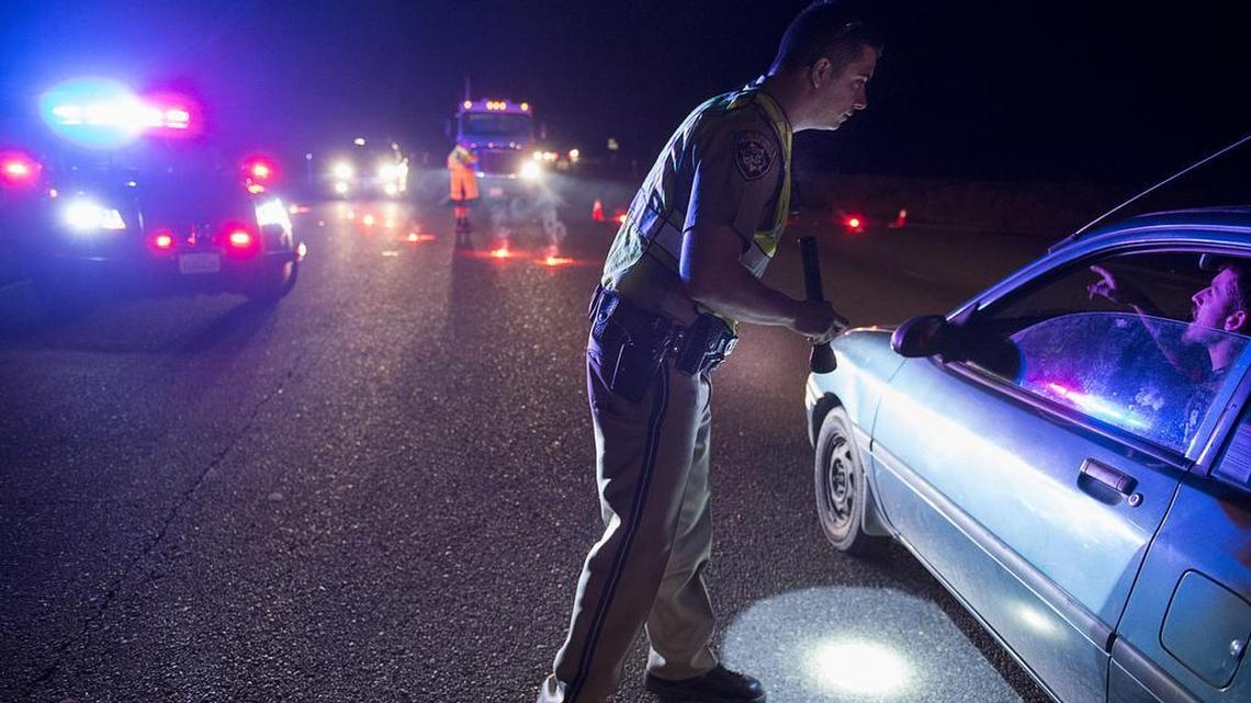 CHP Officer Ken Weckman directs traffic on Highway 70 as residents evacuate Marysville because of a possible failure of the emergency spillway at Oroville Dam on Feb. 12 in Marysville.
