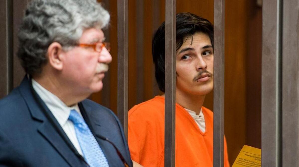 Attorney John Renwich stands with twin Cody Martinez as he is arraigned in the Sacramento Superior Court on Wednesday, March 2, 2016 after allegedly stabbing his mother and stepfather outside their north Sacramento apartment on Monday, Feb. 28, 2016 in Sacramento, Calif.