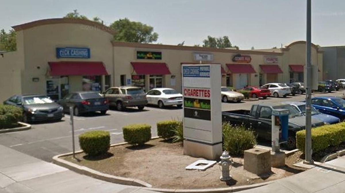 A Google Earth image shows the strip mall where the businesses are located.