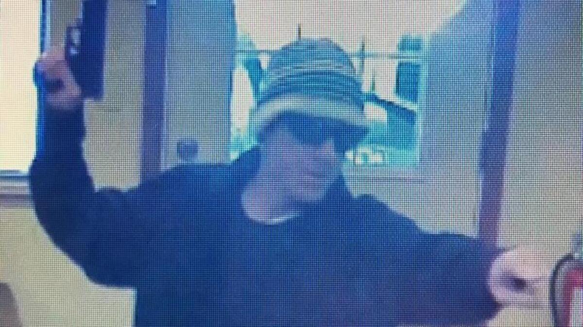 A man shown brandishing a handgun during a May 9, 2017 robbery of an El Dorado Savings Bank in Nevada County is believed to be the Khaki Bandit sought in connection with numerous Northern California bank robberies.