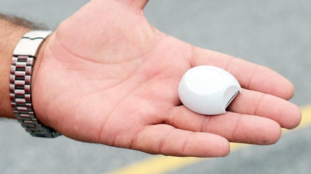 Garry Murphy holds a miniature transmitter designed to be worn by dementia patients or others who might be prone to wandering off. Aug. 30, 2012.