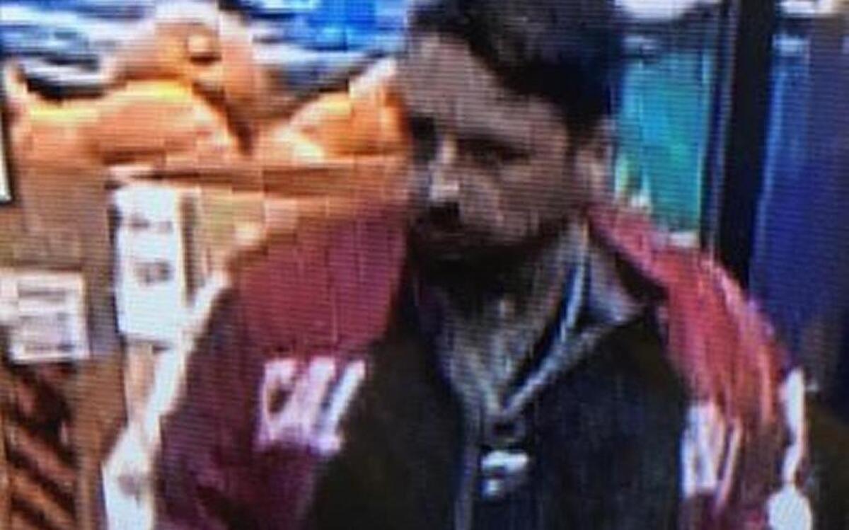 Police say the man shown in this surveillance photo is wearing the jacket he is accused of stealing from a Roseville store.