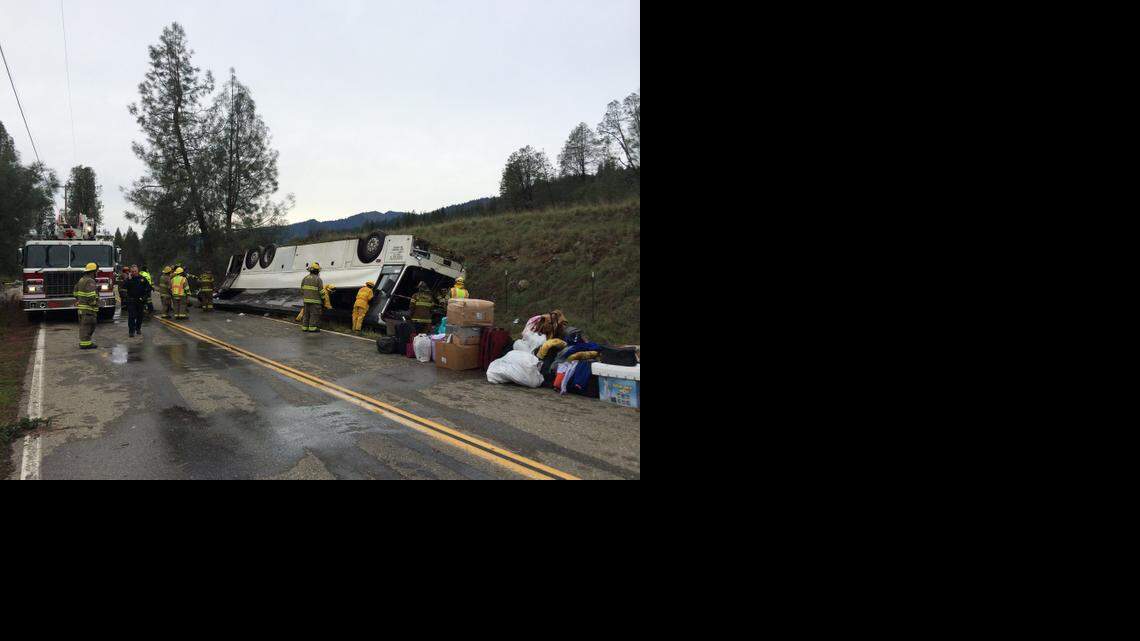 
Emergency personnel on Sunday check a tour bus that crashed earlier in the day, then overturned off Interstate 5 near Pollard Flat in Shasta County. The crash killed one person and sent dozens to hospitals.
