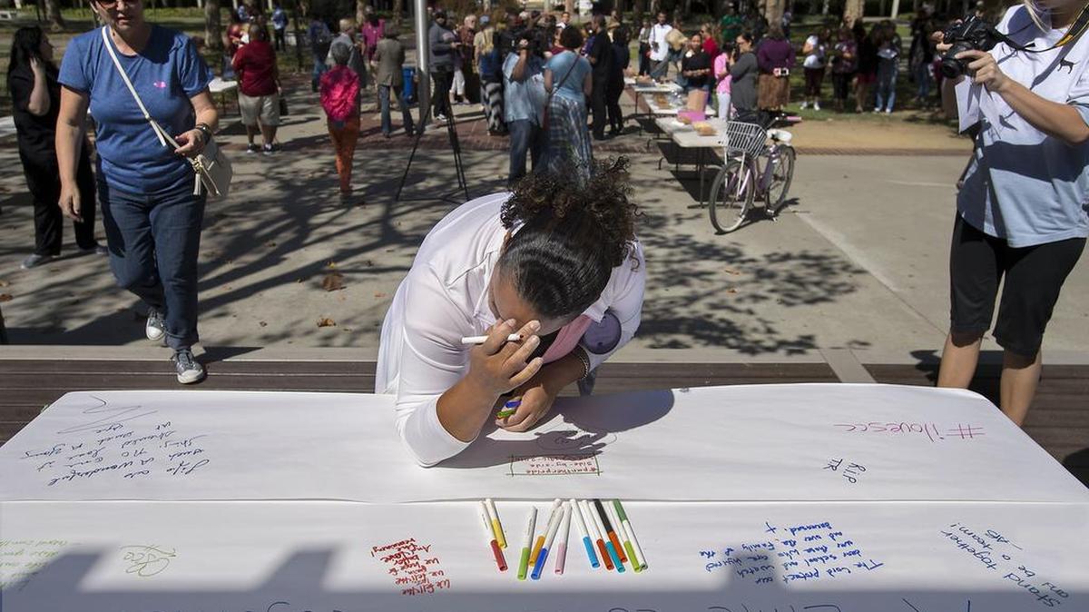 Sacramento City College staff member Diana Daniels tearfully collects her thoughts to add to a banner at Sacramento City College in Sacramento on Friday, September 4, 2015.