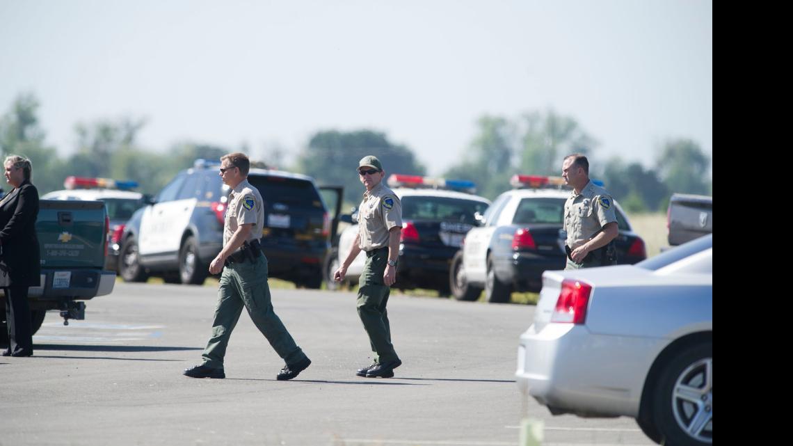
Law enforcement personnel work near the site where a California state game warden shot and killed a suspected marijuana grower Wednesday during a raid at the Stone Lakes National Wildlife Refuge in Elk Grove.
