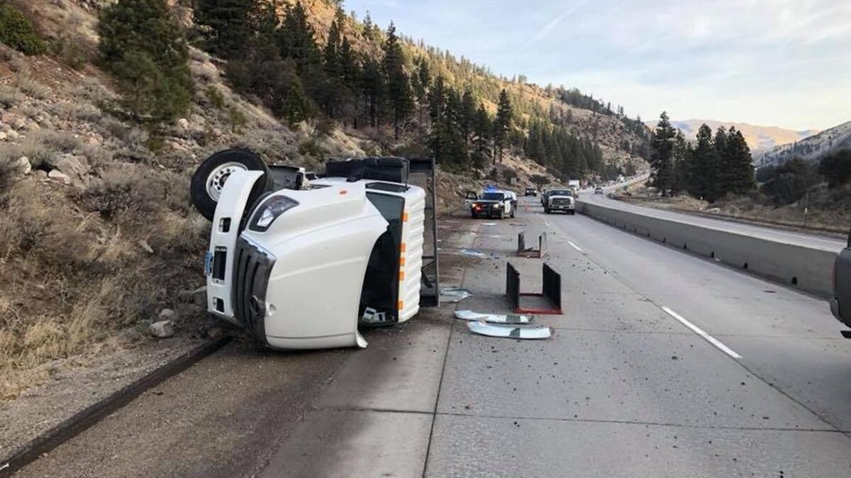 A truck carrying windshields overturned Tuesday morning on westbound Interstate 80 near the Nevada state line.