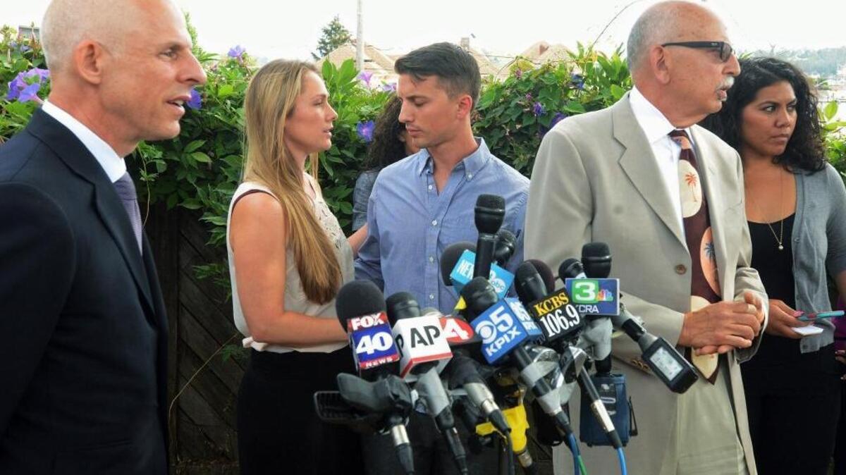 
Denise Huskins and her boyfriend, Aaron Quinn, turn to each other at the end of a news conference on July 13 in Vallejo. At left is Huskins’ attorney, Douglas Rappaport, and second from right is Quinn’s attorney, Daniel Russo. 
