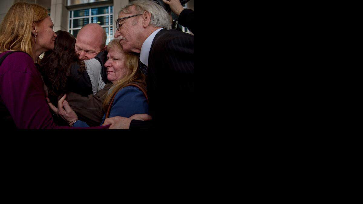 
Eileen and George McDavid, right, join in an embrace of their son Eric along with his sister Sarah McDavid, left, and girlfriend, Jenny Esquivel, outside the federal courthouse in Sacramento. A judge ordered Eric McDavid released Thursday after federal prosecutors agreed to a settlement and admitted that thousands of pages of evidence were withheld from the defense during McDavid’s original trial.
