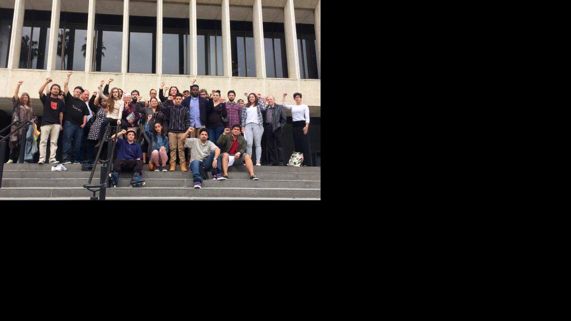
Maile Hampton, 20, in the pale pink pants, poses on the steps of Sacramento Superior Court on March 16 after appearing on charges of lynching and resisting arrest. She is surrounded by people who came to support her at the hearing. 
