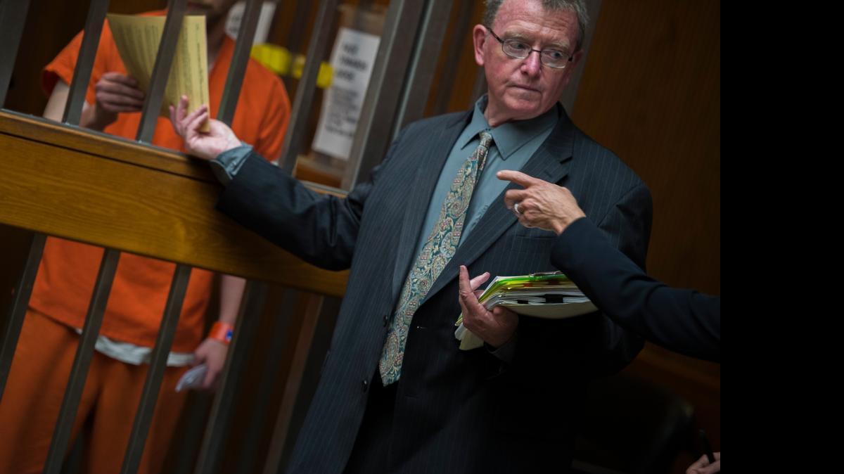 
Defense attorney Robert Bratberg of Santa Rosa passes paperwork to Timothy Brownwell as he appears in court on Thursday at the Sacramento County jail. Brownwell, who did not enter a plea, is accused of uttering several anti-homosexual slurs before stabbing three musicians in midtown this week.
