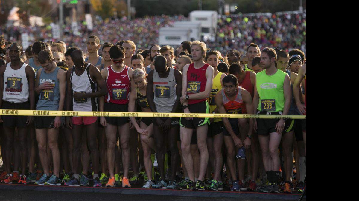 
Runners wait for the race to begin during the 32nd annual California International Marathon on Sunday, Dec. 7, 2014. Organizers of sports events in California’s capital are concerned that the nation’s largest railroad may not allow participants to cross tracks, forcing them to reroute or cancel more races.
